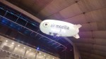 The Air Mozilla Blimp passes above the Microsoft Stand